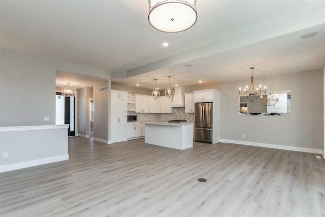 5750 Meadow Grass Cir SE, Cedar Rapids, IA 52403 - unfurnished living room featuring a chandelier, recessed lighting, and light wood-type flooring
