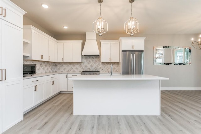5750 Meadow Grass Cir SE, Cedar Rapids, IA 52403 - kitchen featuring appliances with stainless steel finishes, custom exhaust hood, a chandelier, light wood finished floors, and decorative backsplash
