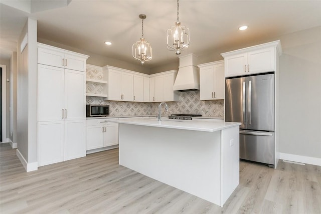 5750 Meadow Grass Cir SE, Cedar Rapids, IA 52403 - kitchen featuring appliances with stainless steel finishes, a chandelier, light countertops, open shelves, and custom range hood