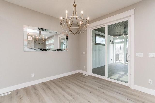 5750 Meadow Grass Cir SE, Cedar Rapids, IA 52403 - spare room featuring a chandelier and wood finished floors