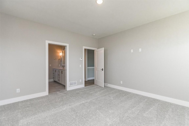 5750 Meadow Grass Cir SE, Cedar Rapids, IA 52403 - unfurnished bedroom featuring light colored carpet and ensuite bath