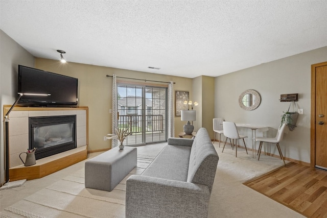 2861 Coral Ct Unit 302, Coralville, IA 52241 - living room featuring a fireplace and a textured ceiling