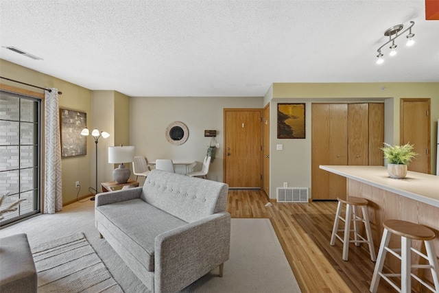 2861 Coral Ct Unit 302, Coralville, IA 52241 - living area featuring light wood-style flooring and a textured ceiling
