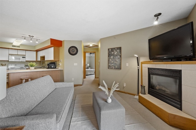 2861 Coral Ct Unit 302, Coralville, IA 52241 - living room with light colored carpet and a tile fireplace