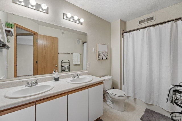 2861 Coral Ct Unit 302, Coralville, IA 52241 - bathroom with double vanity, a textured ceiling, and shower / tub combo with curtain