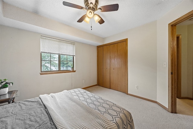 2861 Coral Ct Unit 302, Coralville, IA 52241 - bedroom with light carpet, a closet, ceiling fan, and a textured ceiling