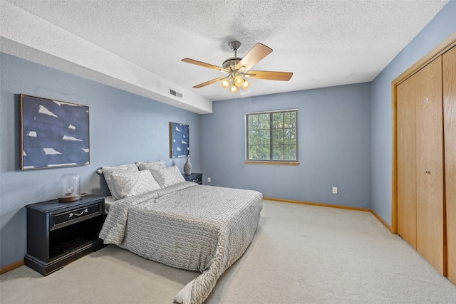 2861 Coral Ct Unit 302, Coralville, IA 52241 - bedroom featuring light colored carpet, a closet, ceiling fan, and a textured ceiling