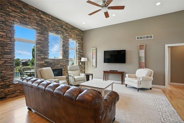 701 Sherwood Dr, Iowa City, IA 52245 - living room featuring ceiling fan, light wood finished floors, recessed lighting, and a fireplace