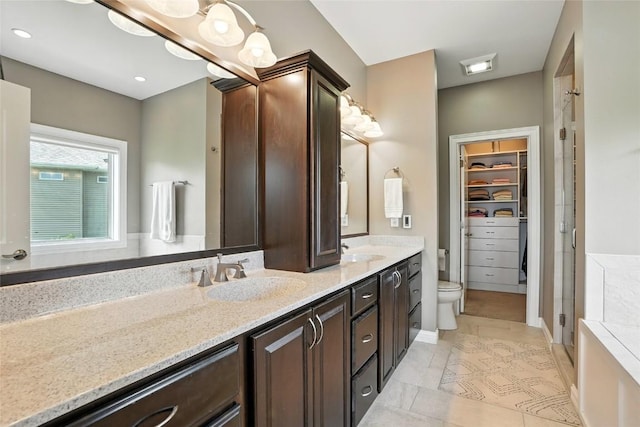 701 Sherwood Dr, Iowa City, IA 52245 - full bath with double vanity, a stall shower, and a walk in closet