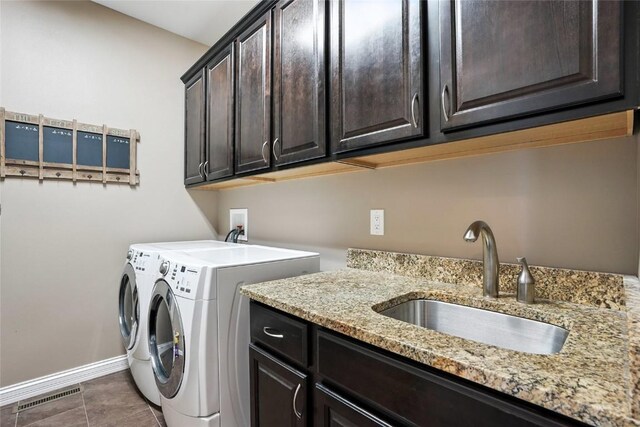 701 Sherwood Dr, Iowa City, IA 52245 - washroom with cabinet space, separate washer and dryer, and tile patterned flooring