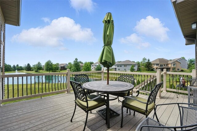 701 Sherwood Dr, Iowa City, IA 52245 - wooden terrace featuring outdoor dining space, a residential view, and a water view