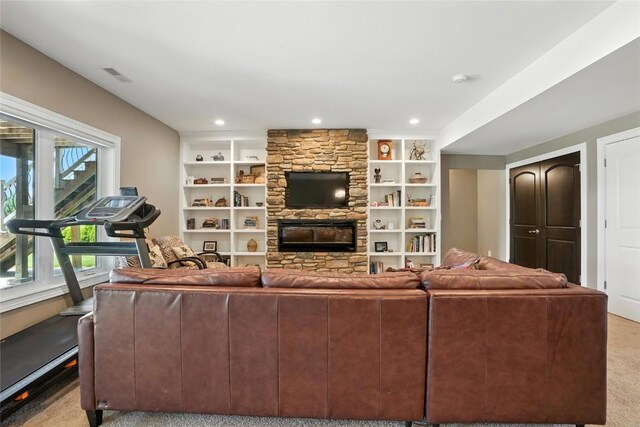 701 Sherwood Dr, Iowa City, IA 52245 - living area featuring light colored carpet, a fireplace, recessed lighting, and built in shelves