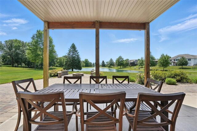 701 Sherwood Dr, Iowa City, IA 52245 - view of patio with outdoor dining area and a water view