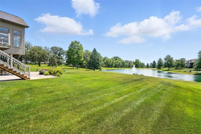 701 Sherwood Dr, Iowa City, IA 52245 - view of grassy yard with a water view and stairway