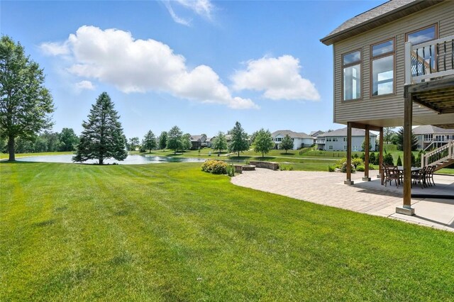 701 Sherwood Dr, Iowa City, IA 52245 - view of green lawn with a water view and a patio area