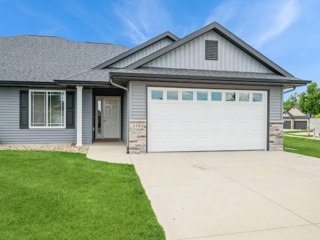 3502 Bluebird Dr SW, Cedar Rapids, IA 52404 - ranch-style house featuring an attached garage, board and batten siding, a front lawn, and concrete driveway