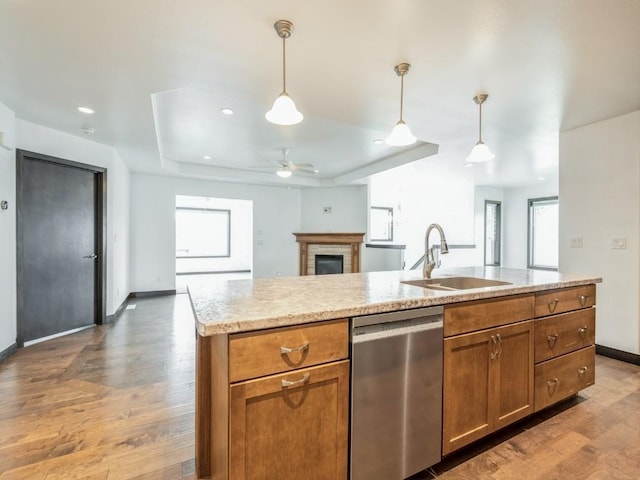3502 Bluebird Dr SW, Cedar Rapids, IA 52404 - kitchen featuring dishwasher, light wood-type flooring, a brick fireplace, brown cabinets, and recessed lighting