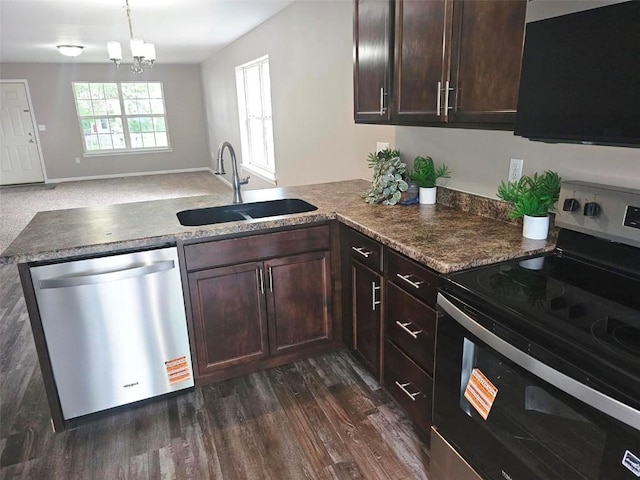 441 8th Ave SW, Cedar Rapids, IA 52404 - kitchen featuring appliances with stainless steel finishes, a peninsula, dark brown cabinetry, dark wood finished floors, and a chandelier