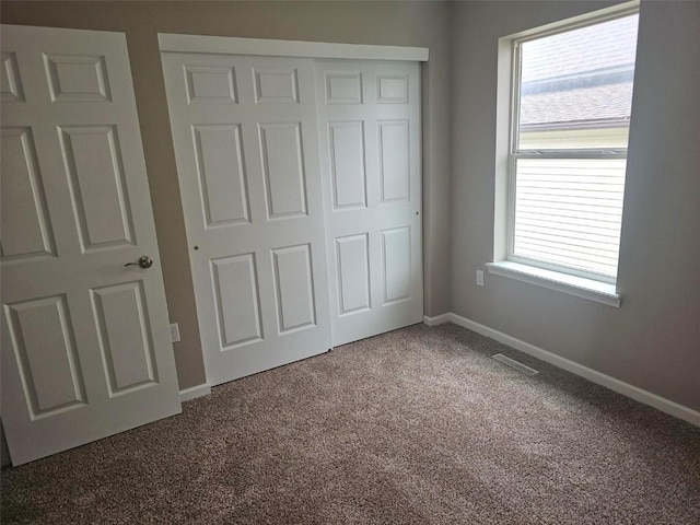 441 8th Ave SW, Cedar Rapids, IA 52404 - unfurnished bedroom featuring carpet and a closet