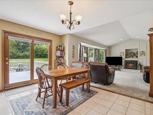 725 High Point Dr SW, Cedar Rapids, IA 52404 - dining area featuring light tile patterned floors, plenty of natural light, a chandelier, vaulted ceiling, and a textured ceiling