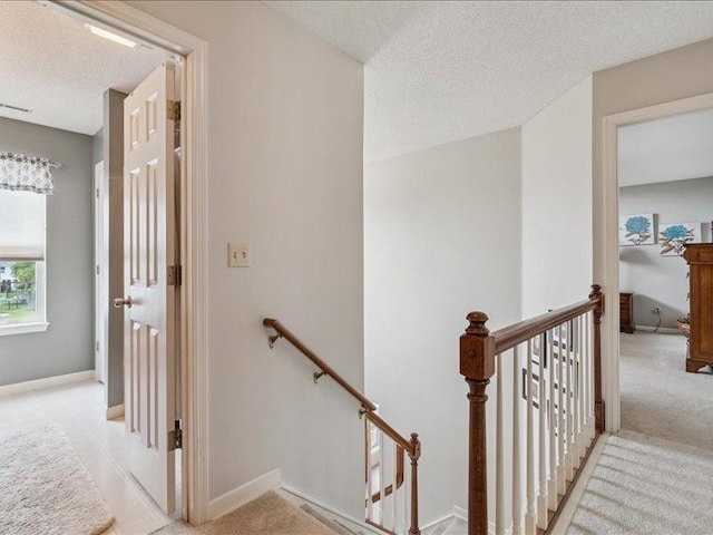 725 High Point Dr SW, Cedar Rapids, IA 52404 - stairs featuring a textured ceiling and carpet flooring