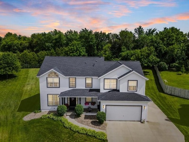 725 High Point Dr SW, Cedar Rapids, IA 52404 - view of front of house with covered porch, concrete driveway, a yard, a garage, and a shingled roof