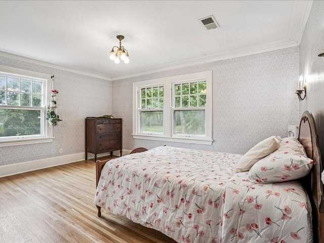 206 Kingbard Blvd, Waterloo, IA 50701 - bedroom with crown molding, wood finished floors, a chandelier, and wallpapered walls