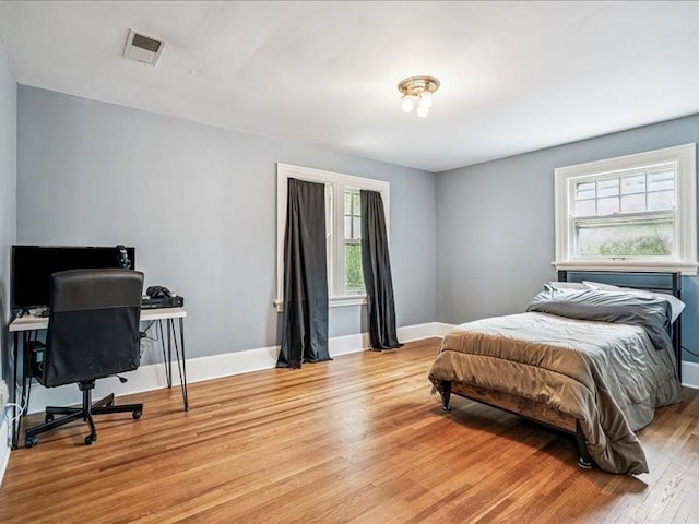 206 Kingbard Blvd, Waterloo, IA 50701 - bedroom with light wood finished floors and an office area