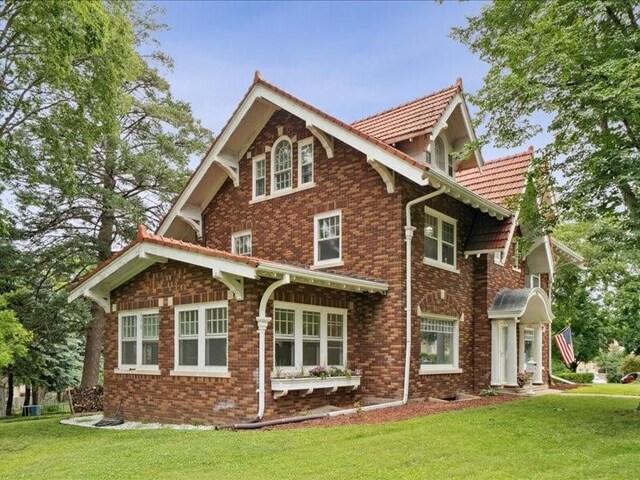 206 Kingbard Blvd, Waterloo, IA 50701 - view of property exterior featuring a yard and brick siding