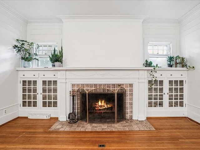 206 Kingbard Blvd, Waterloo, IA 50701 - detailed view of wood finished floors, a brick fireplace, and ornamental molding