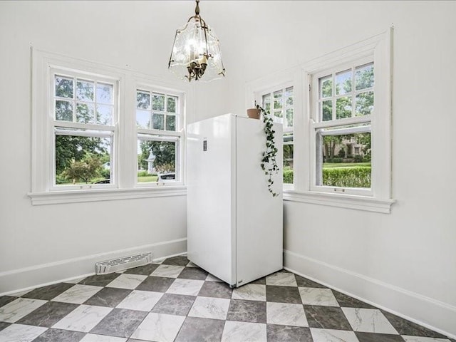 206 Kingbard Blvd, Waterloo, IA 50701 - unfurnished dining area featuring a chandelier and plenty of natural light