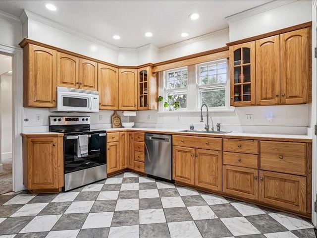 206 Kingbard Blvd, Waterloo, IA 50701 - kitchen featuring appliances with stainless steel finishes, crown molding, brown cabinets, glass insert cabinets, and light countertops