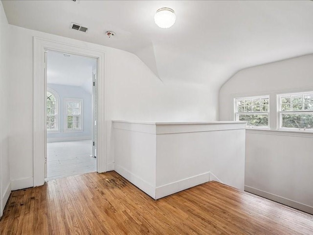 206 Kingbard Blvd, Waterloo, IA 50701 - spare room with lofted ceiling, wood finished floors, plenty of natural light, and a pendent fire sprinkler