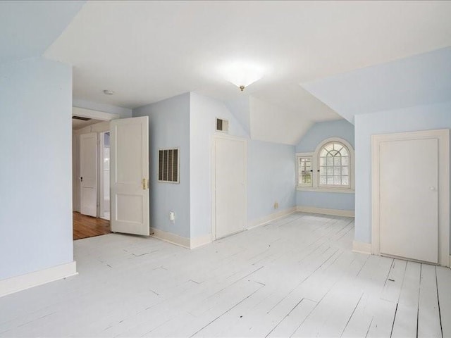 206 Kingbard Blvd, Waterloo, IA 50701 - additional living space featuring vaulted ceiling and light wood-type flooring