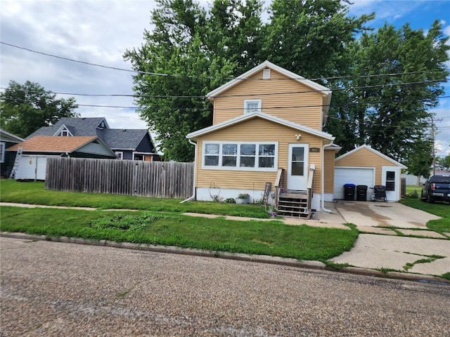 904 10th St, Belle Plaine, IA 52208 - traditional home with concrete driveway, a garage, an outbuilding, and entry steps