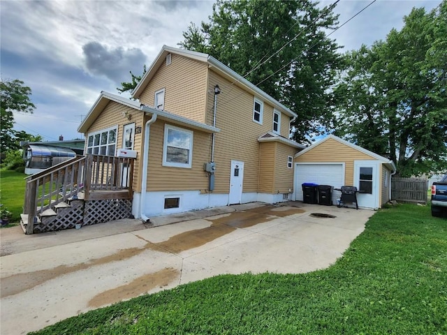 904 10th St, Belle Plaine, IA 52208 - view of home's exterior with an outdoor structure, a detached garage, and driveway