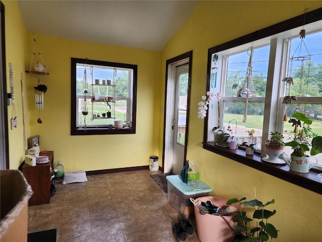 904 10th St, Belle Plaine, IA 52208 - doorway to outside with vaulted ceiling and tile patterned floors