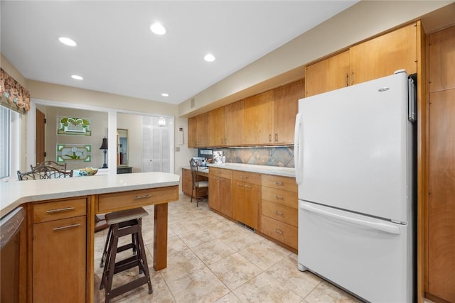 1104 Mulberry St, Tipton, IA 52772 - kitchen with freestanding refrigerator, dishwashing machine, light countertops, decorative backsplash, and light tile patterned floors