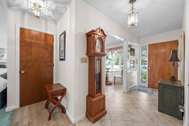 1104 Mulberry St, Tipton, IA 52772 - foyer featuring baseboards and a chandelier