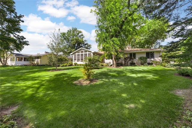 1104 Mulberry St, Tipton, IA 52772 - view of green lawn with a sunroom