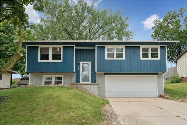 1708 Woodside Ct NW, Cedar Rapids, IA 52405 - raised ranch featuring brick siding, a garage, a front lawn, and concrete driveway