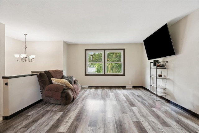1708 Woodside Ct NW, Cedar Rapids, IA 52405 - sitting room featuring a chandelier and light wood-style flooring
