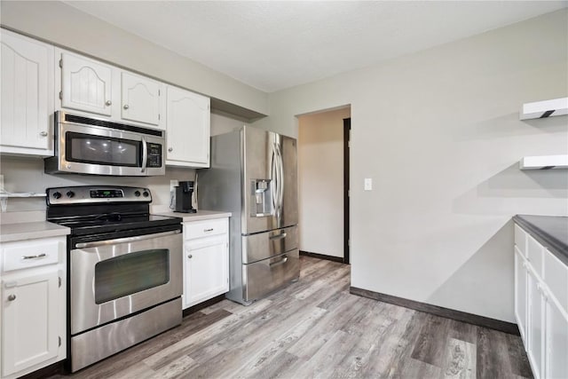 1708 Woodside Ct NW, Cedar Rapids, IA 52405 - kitchen with stainless steel appliances, light wood-type flooring, white cabinetry, and light countertops