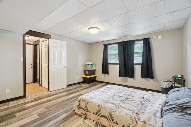 1708 Woodside Ct NW, Cedar Rapids, IA 52405 - bedroom featuring wood finished floors and a drop ceiling
