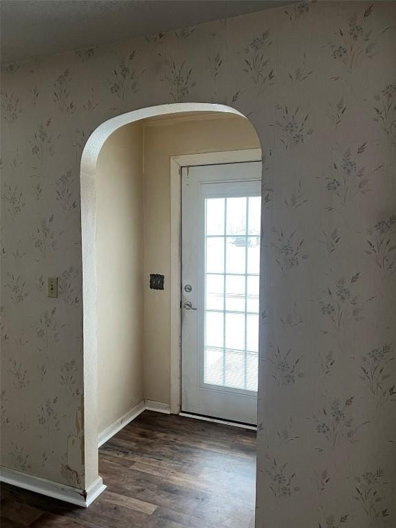 201 S 8th Ave, Vinton, IA 52349 - doorway to outside featuring arched walkways and dark wood-style flooring