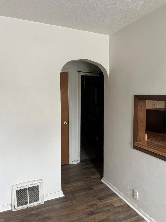 201 S 8th Ave, Vinton, IA 52349 - empty room with arched walkways and dark wood-type flooring