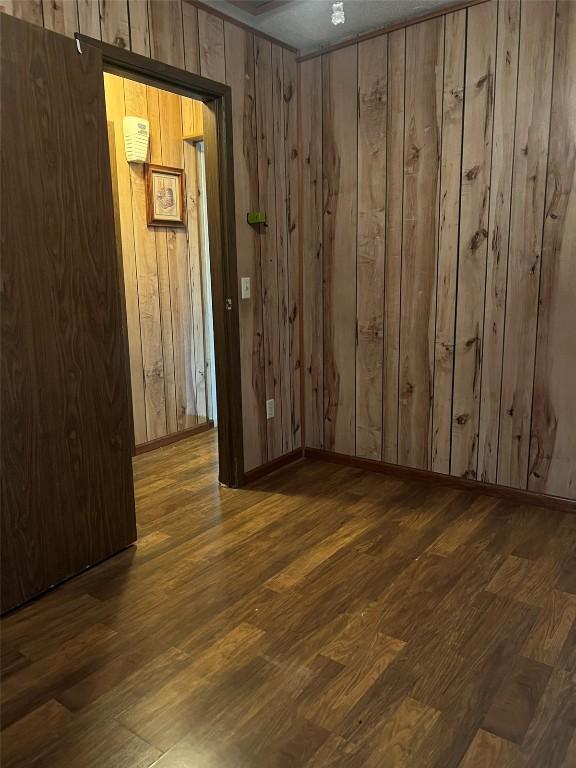 201 S 8th Ave, Vinton, IA 52349 - unfurnished room with wood finished floors and wooden walls