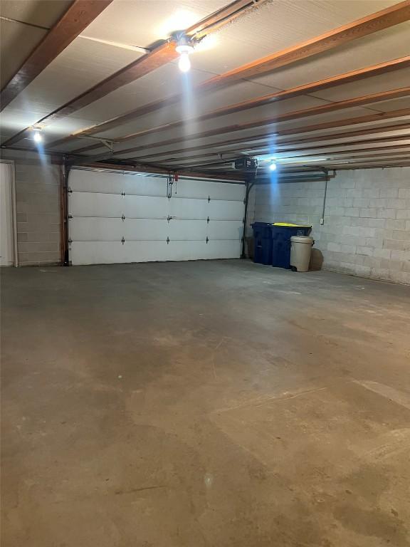 201 S 8th Ave, Vinton, IA 52349 - garage with concrete block wall and a garage door opener