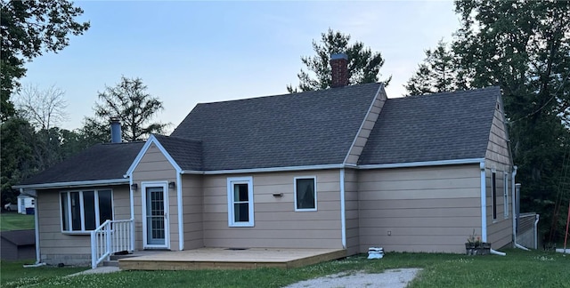 201 S 8th Ave, Vinton, IA 52349 - back of property featuring a chimney, a yard, a wooden deck, and a shingled roof