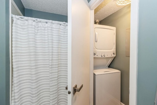 2135 1st Ave SE Unit 125, Cedar Rapids, IA 52402 - laundry area featuring stacked washer / drying machine and a textured ceiling